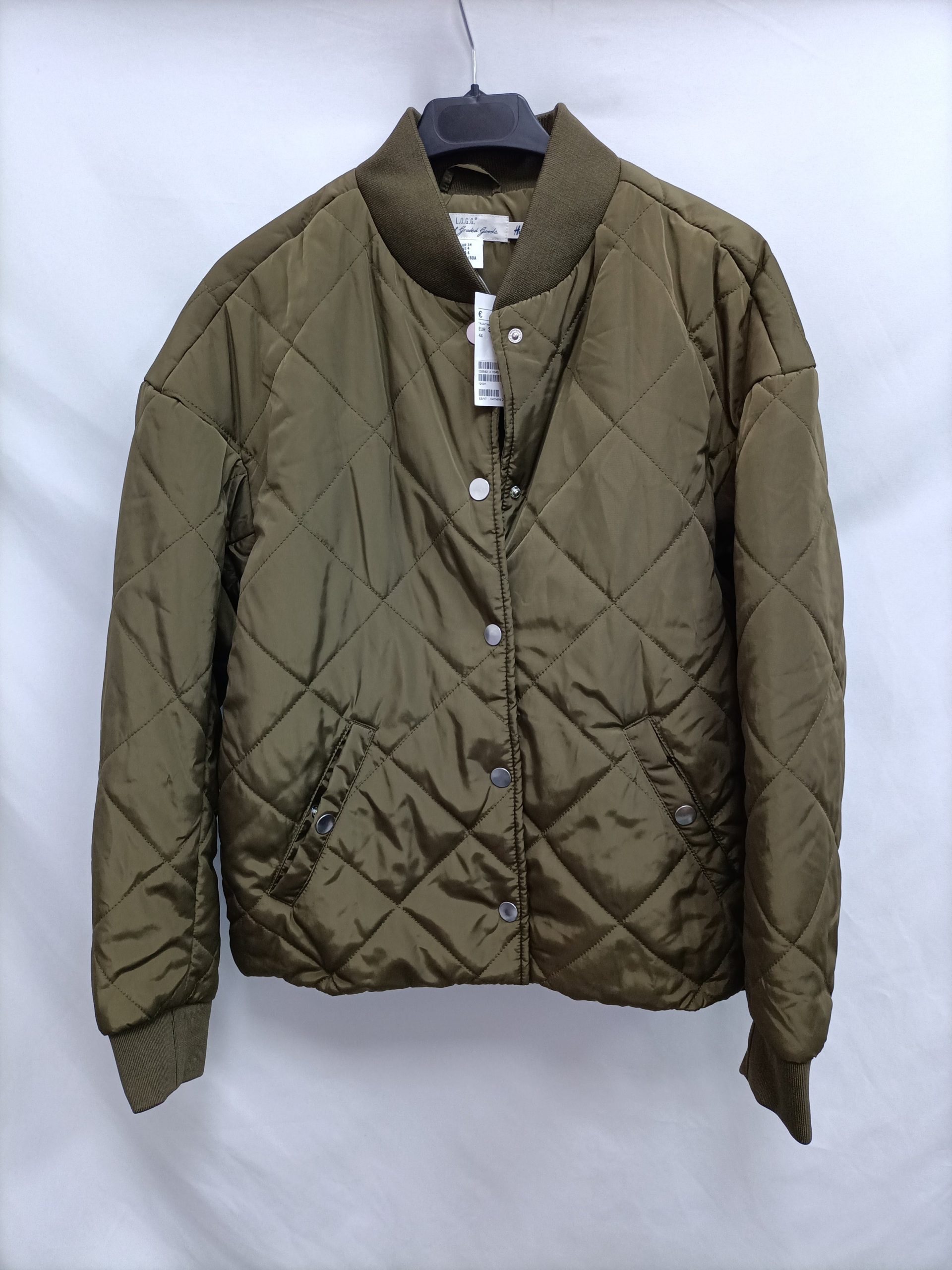 H&M. Plumas verde corto T.34