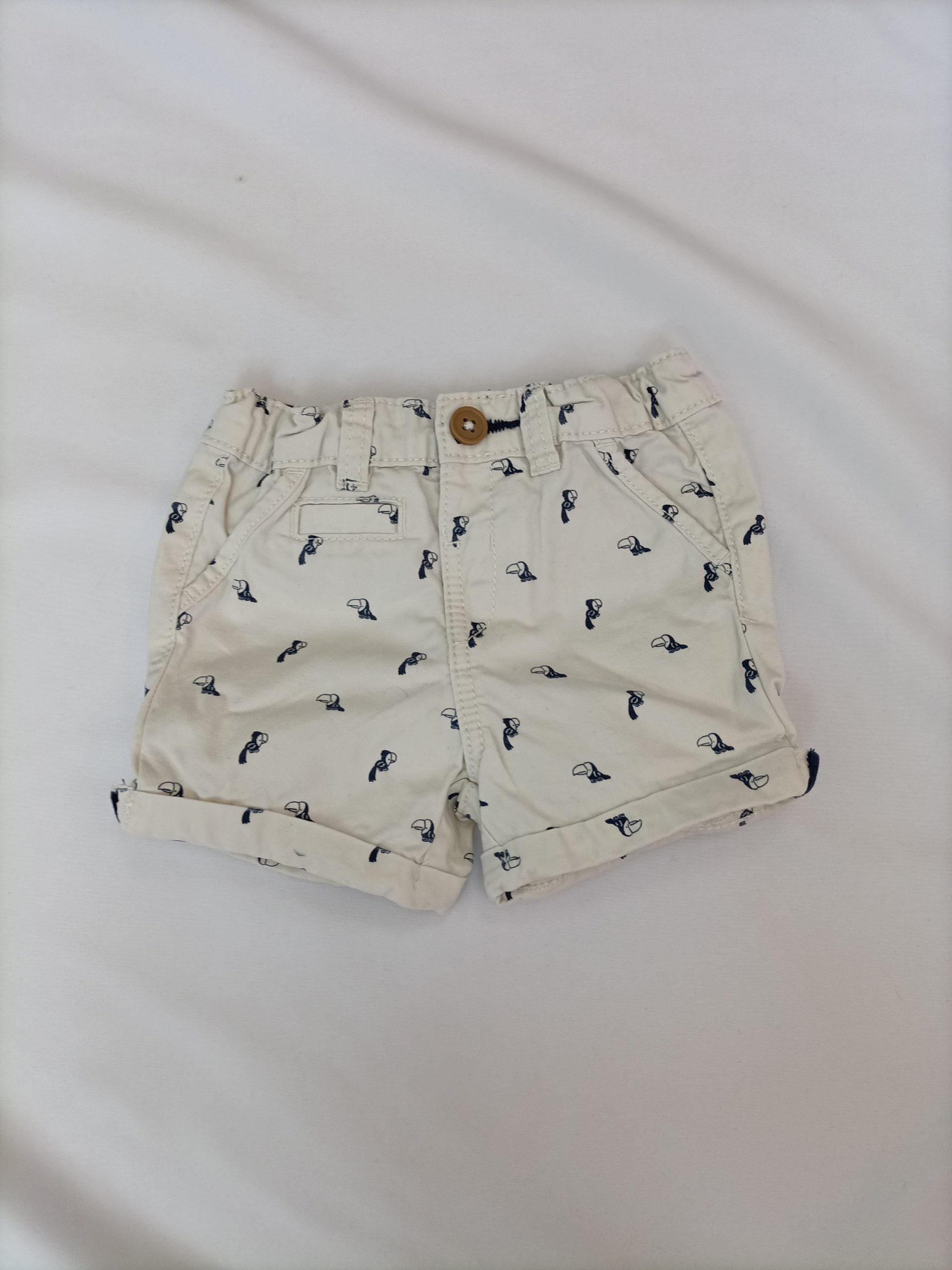 KIABI. Pantalón beige pajaros T.6 meses