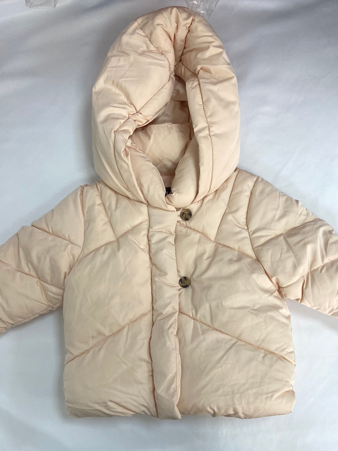 KIABI.Plumas beige rosita 9 meses